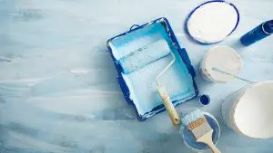 Fresh interior paint supplies laid out for a winter project, illustrating how to choose low-odor paint for winter interior projects to maintain indoor comfort