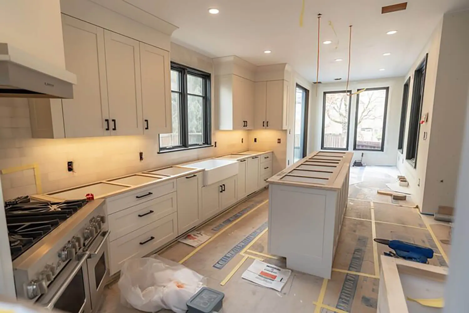 Freshly painted kitchen cabinets during a winter renovation, showing why is winter a good time to paint cabinets in Bloomfield Hills.