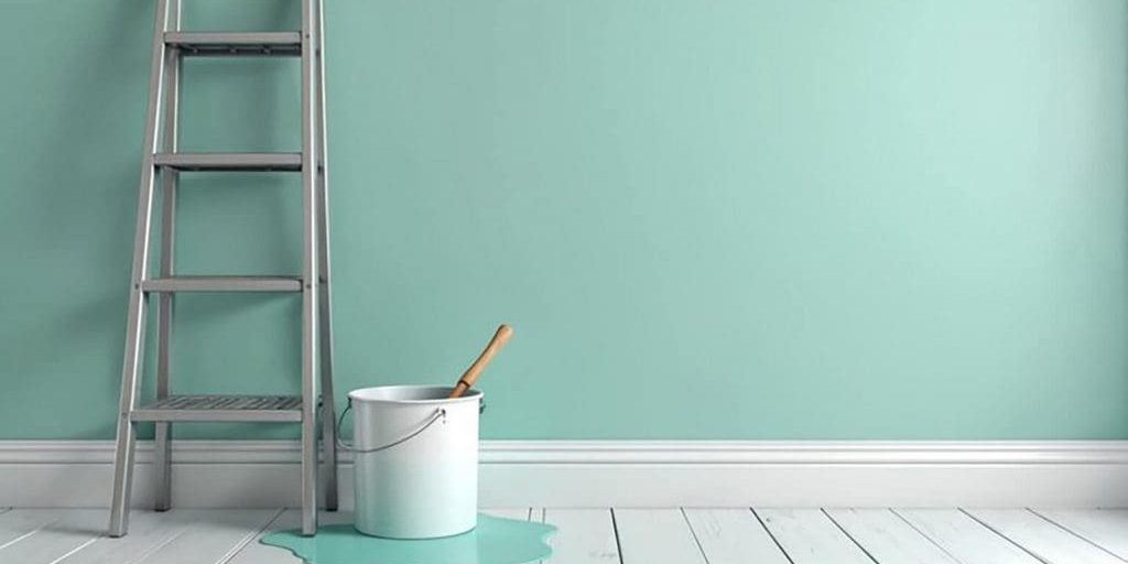 Interior painting setup showing a mint green wall, ladder, and paint bucket, illustrating how to plan a spring paint refresh for your Northville home.