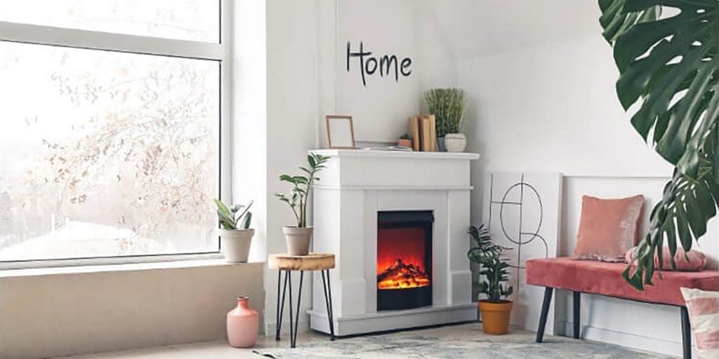 Bright living room with white walls and fireplace showing how interior paint holds up in winter conditions