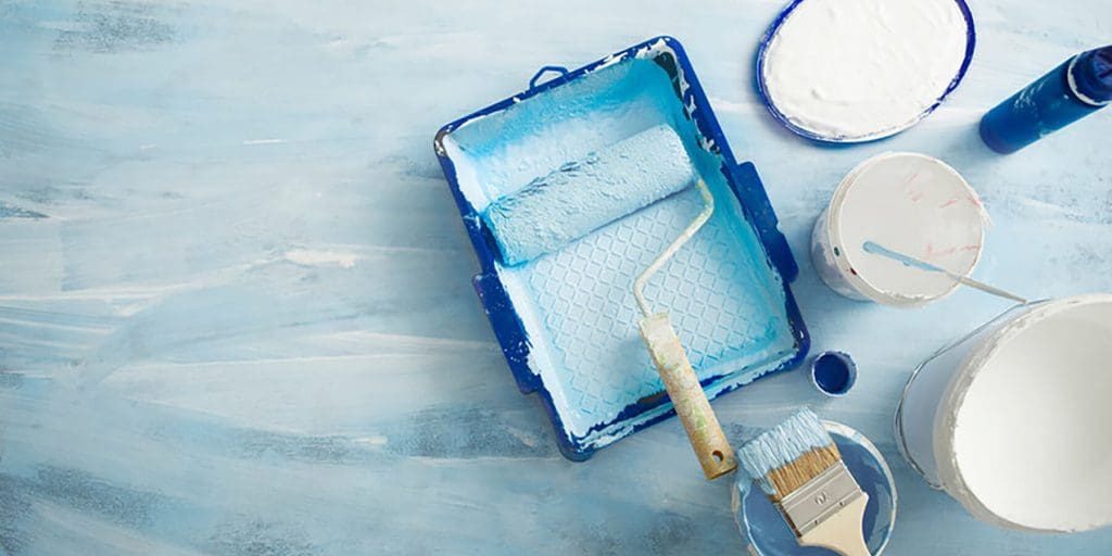 Fresh interior paint supplies laid out for a winter project, illustrating how to choose low-odor paint for winter interior projects to maintain indoor comfort