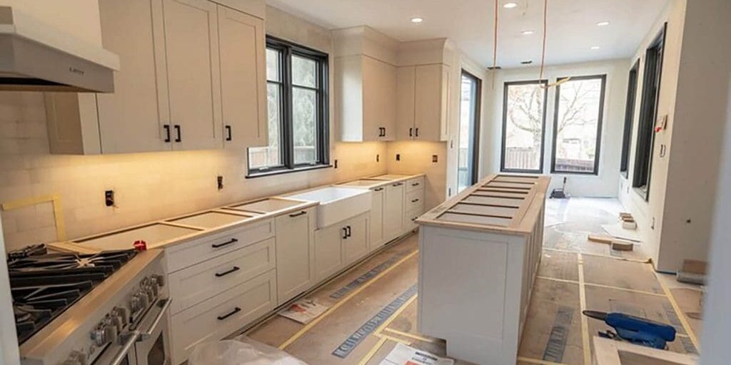 Freshly painted kitchen cabinets during a winter renovation, showing why is winter a good time to paint cabinets in Bloomfield Hills.